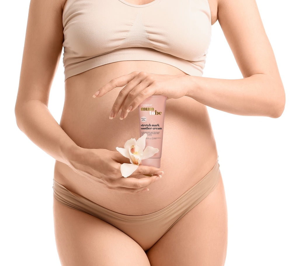 Pregnant woman holding Mum To Be Stretch Mark Soother Cream.